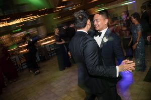 Two men dancing at a wedding reception in New York.