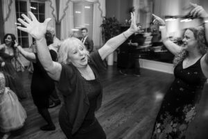 A black and white photo of people dancing at a wedding in New York.