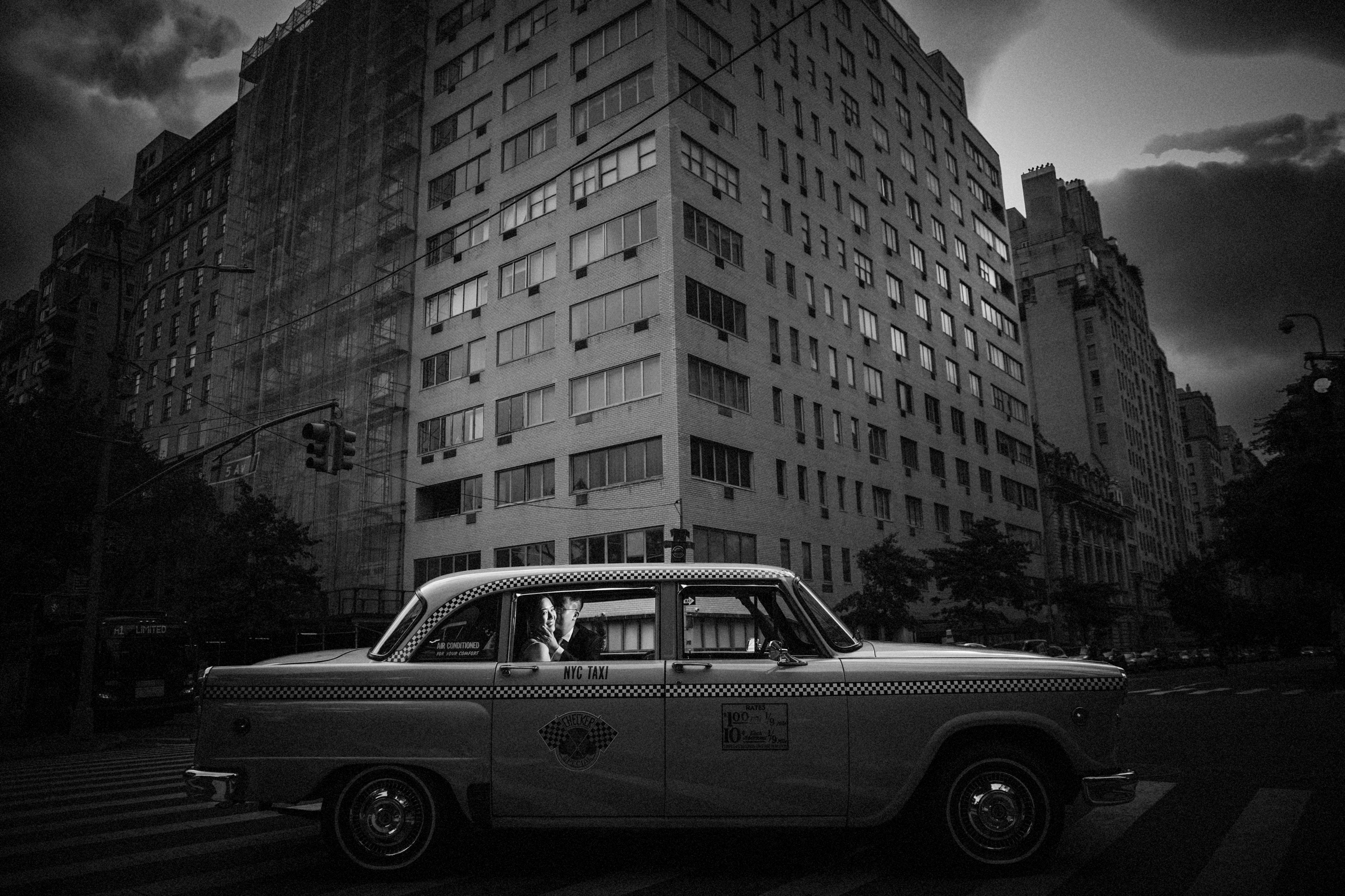wedding couple with vintage cab in nyc in black and white on their wedding day