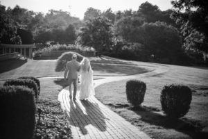 Wedding at Ashford Estate photo of the bride and groom walking down the path to the gazebo