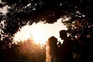 Wedding at Ashford Estate dramatic photo of the bride and groom in a silhouette at sunset