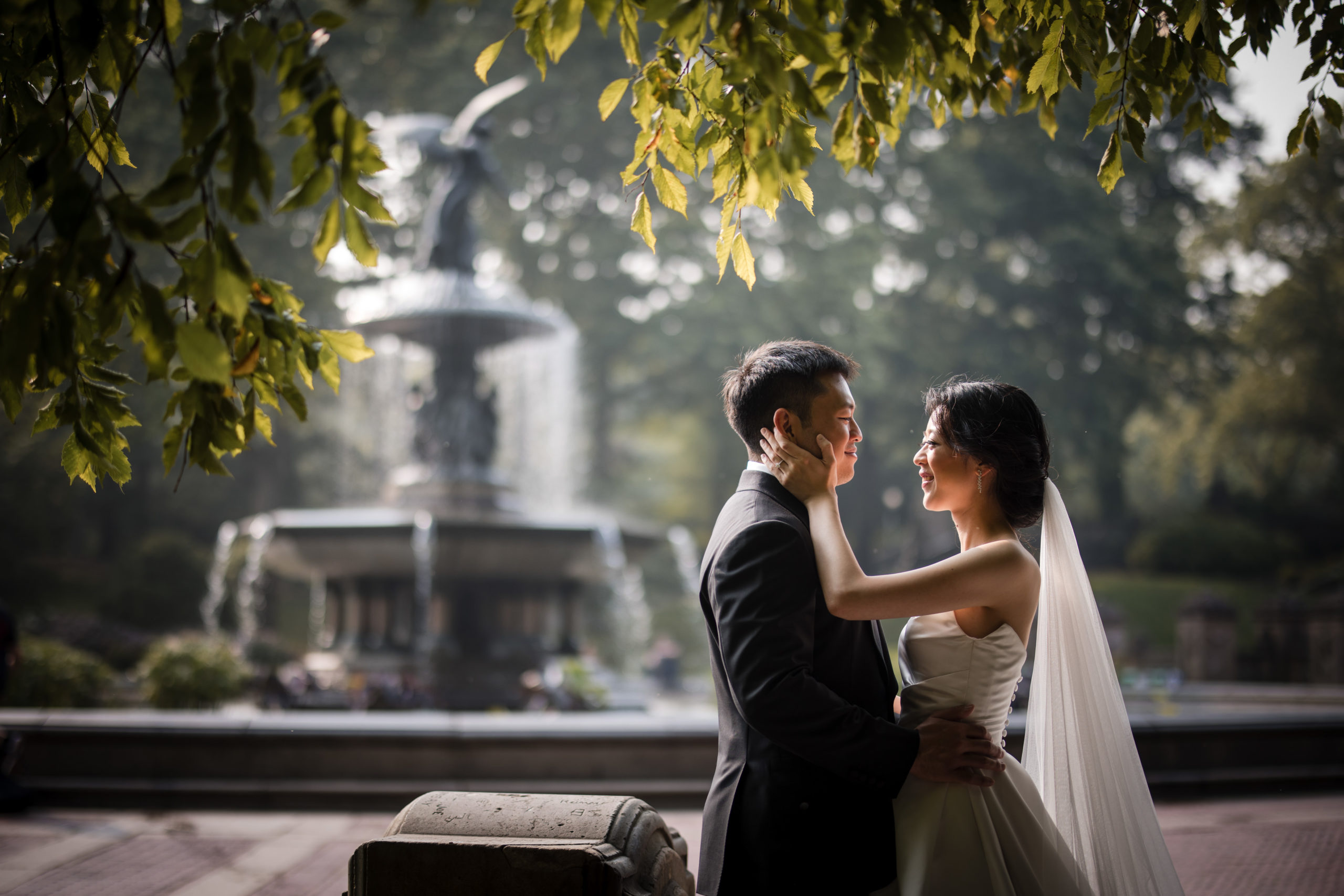 wedding couple with the fountain at a central park elopement