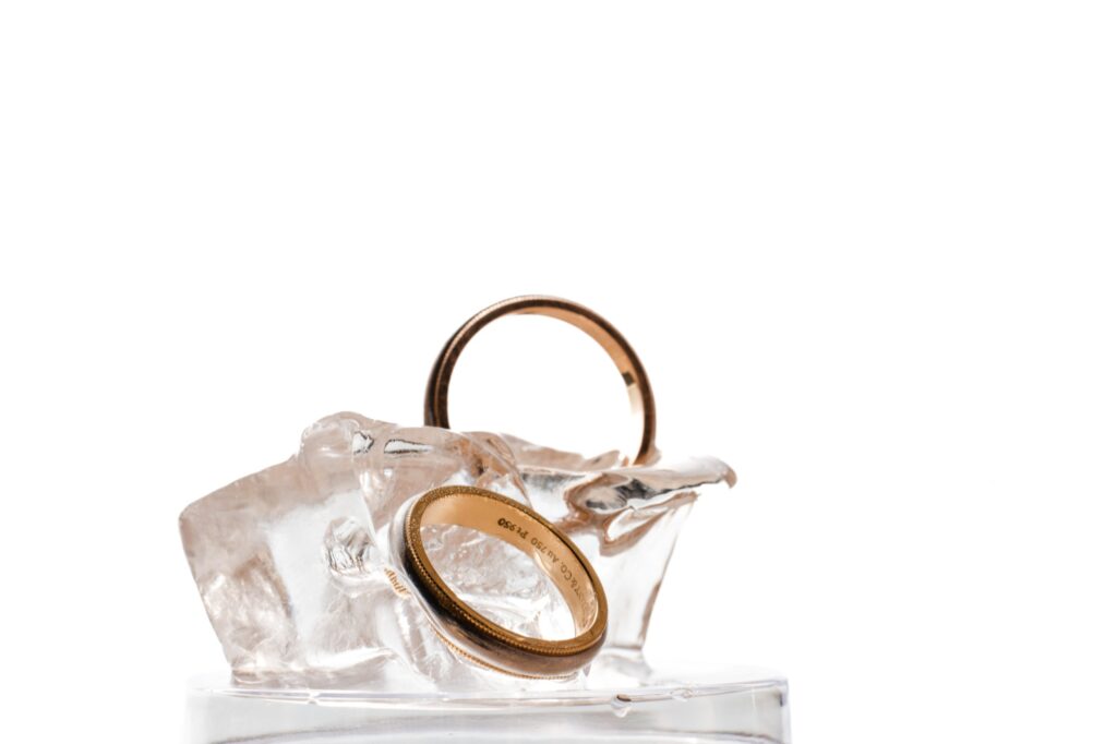 A Liberty Warehouse wedding ring sitting on top of an ice cube.