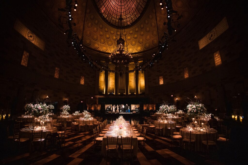 A wedding reception at Gotham Hall, a large room with a chandelier.