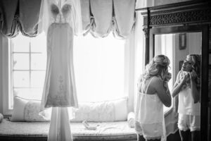 A bride getting ready in front of a mirror.