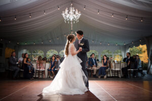 A newlywed couple sharing their first dance at their wedding reception.