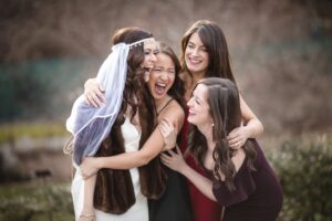 A group of bridesmaids hugging for a photo at a Brooklyn Botanic Garden wedding.