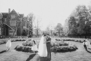 A black and white photo of a bride and groom in front of Sands Point Preserve
