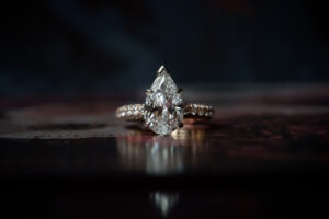 An engagement ring with a pear shaped diamond.