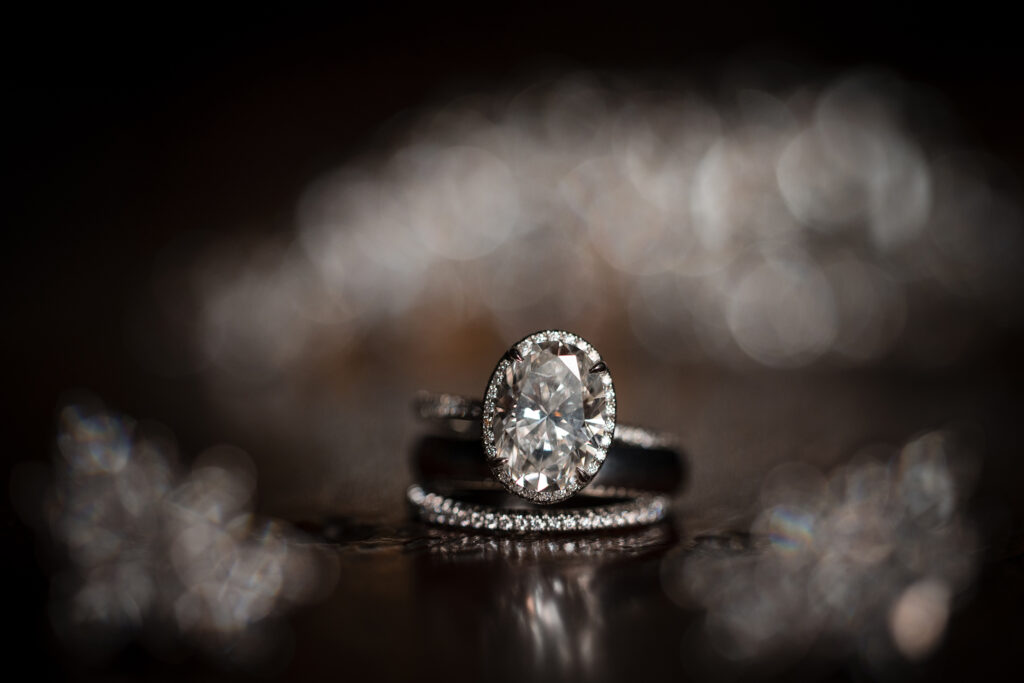 An elegant diamond engagement ring on a black background, symbolizing the evolution of love and the upcoming wedding.