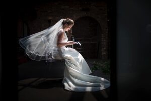 A woman in a wedding dress sitting on a chair at The Foundry wedding venue.