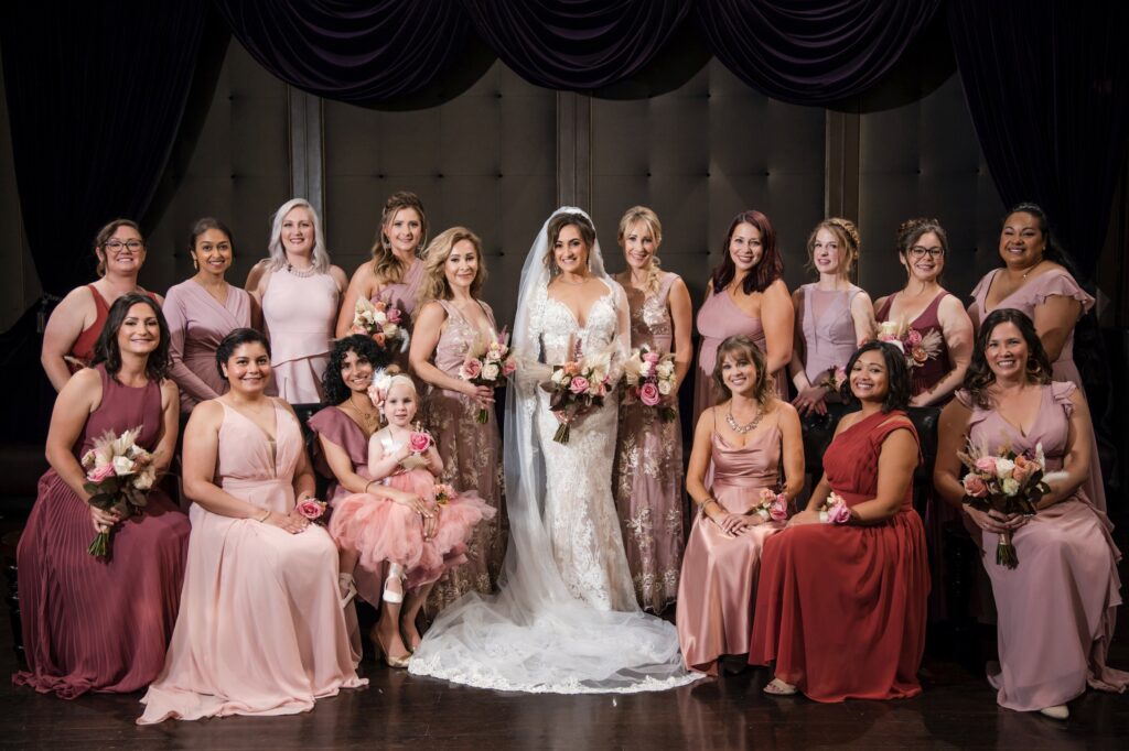 A bride and her bridesmaids posing for a Capitale wedding photo.