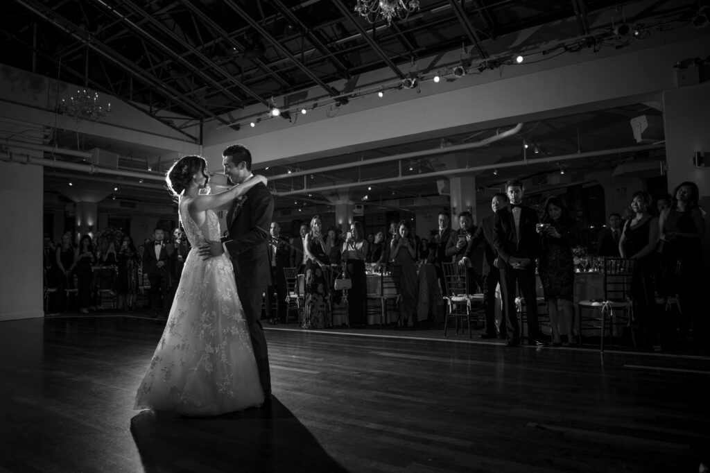 A Tribeca Rooftop wedding captures a bride and groom sharing their first dance in a black and white photo.