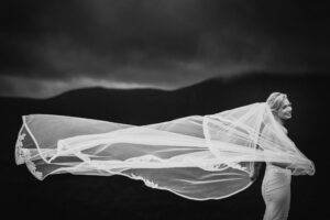 A destination wedding bride with her veil blowing in the wind in Ireland.