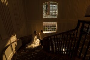 A bride and groom celebrating their Estate at Florentine Gardens wedding on a beautiful staircase.