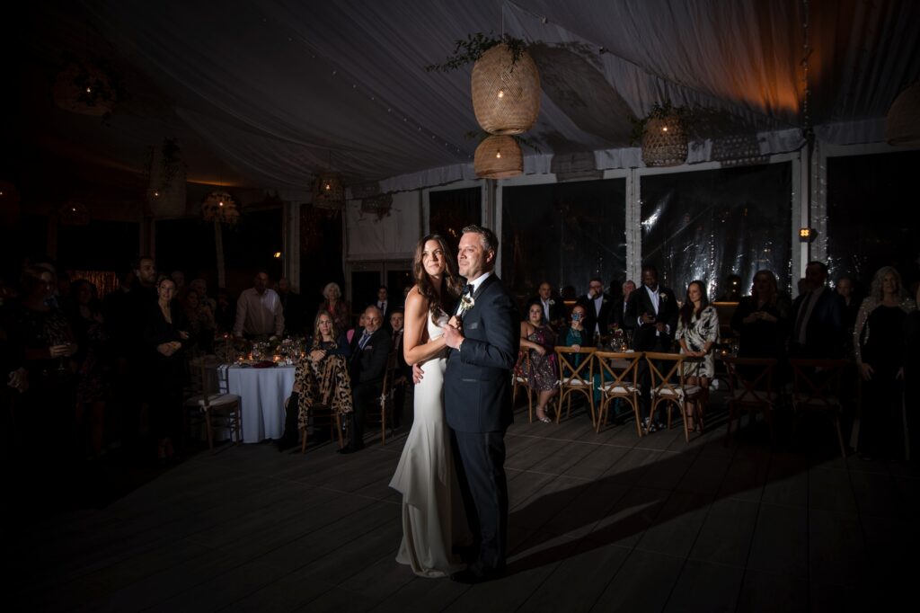 A bride and groom sharing their first dance at a Gurney's Montauk wedding in a tent.