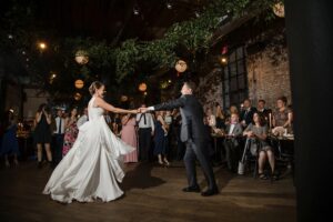 A bride and groom sharing their first dance at a Wythe Hotel wedding.