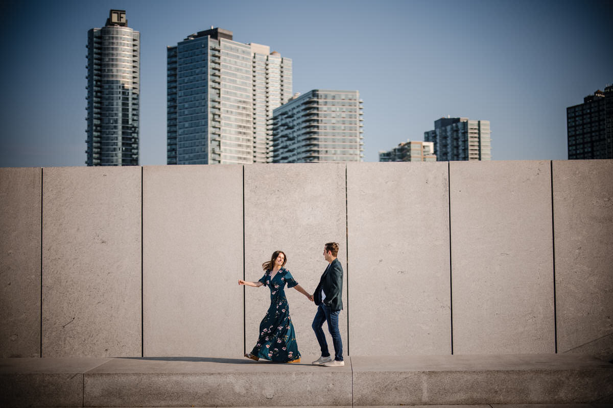 A couple engaging in a lively conversation while strolling through an autumnal landscape, wearing comfortable and casual engagement outfits.