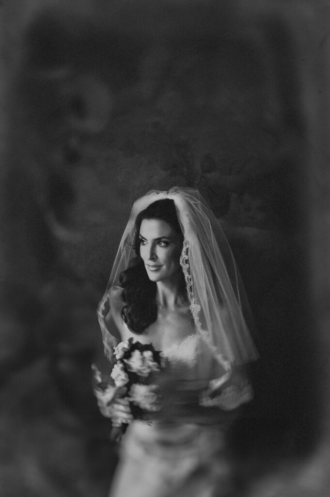 A black and white photo of a bride in a veil at a New Orleans destination wedding.