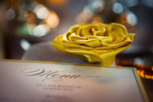 A yellow rose adorns a menu at the Wave Hill wedding.