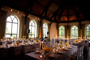 A Wave Hill wedding reception held in a large room with elegantly set tables.