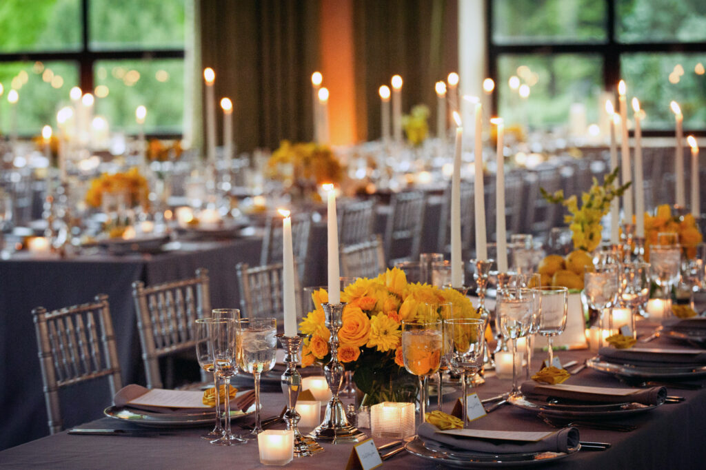A Wave Hill wedding table set up with candles and flowers.