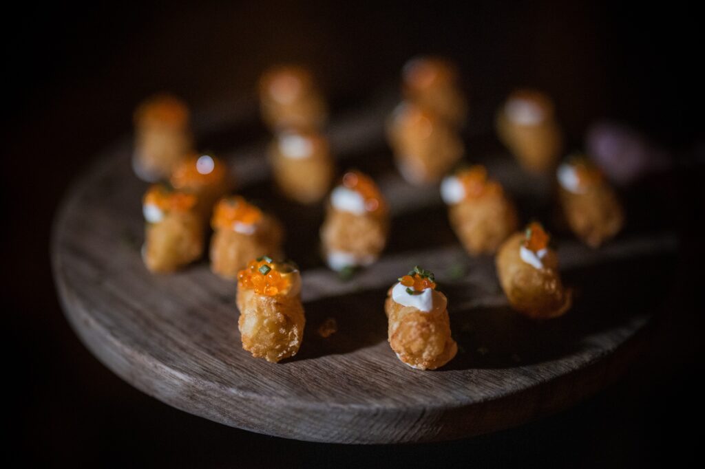 A plate of small appetizers topped with caviar, perfect for a Soho wedding at the Modernhaus.