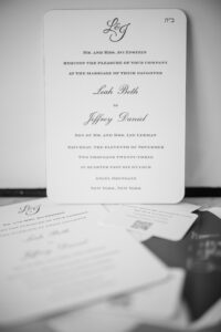 A elegant wedding invitation sitting on a table.