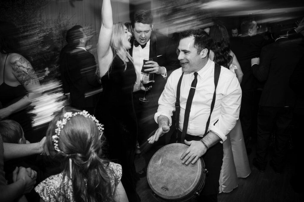 A man is playing a drum at a reception party at Twenty-Three Grand in Modernhaus