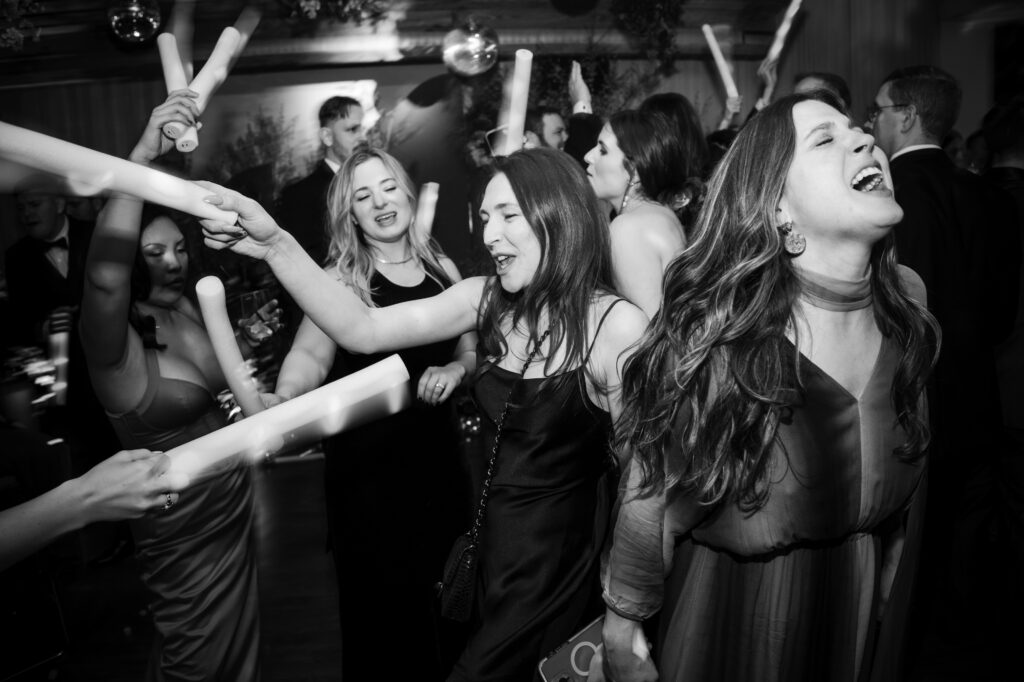 A black and white photo of a group of people dancing at a Modernhaus Soho wedding.