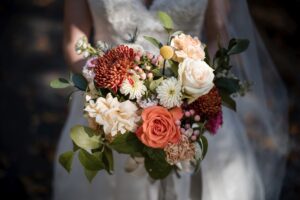 A blissful bride is gracefully holding a stunning bouquet of flowers at her elegant Hotel duPont wedding.