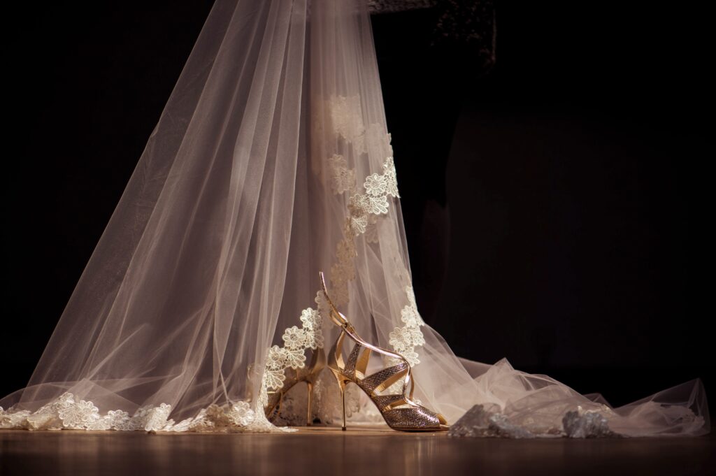 A dancer's shoes and veil against a dark background at the Liberty Warehouse wedding.