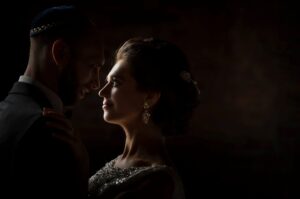 A bride and groom embracing at their Liberty Warehouse wedding in the dark.
