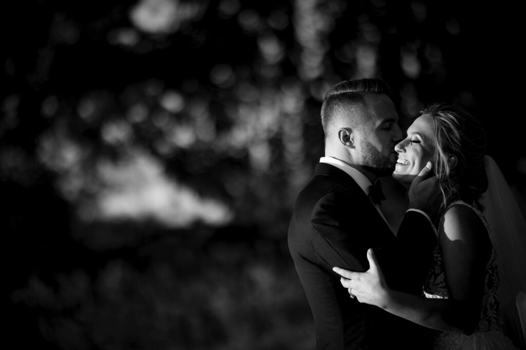 A black and white photo capturing a tender moment between a bride and groom at their Meadow Ridge on the Hudson wedding.