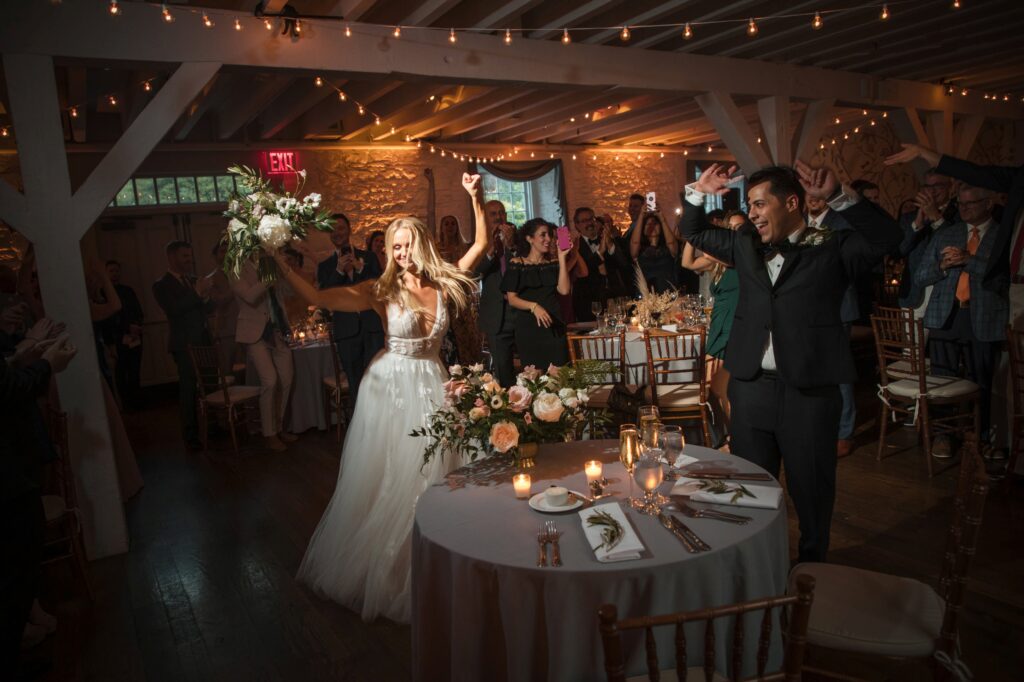 Bride tossing the bouquet at a Bronx Zoo Stone Mill wedding reception.
