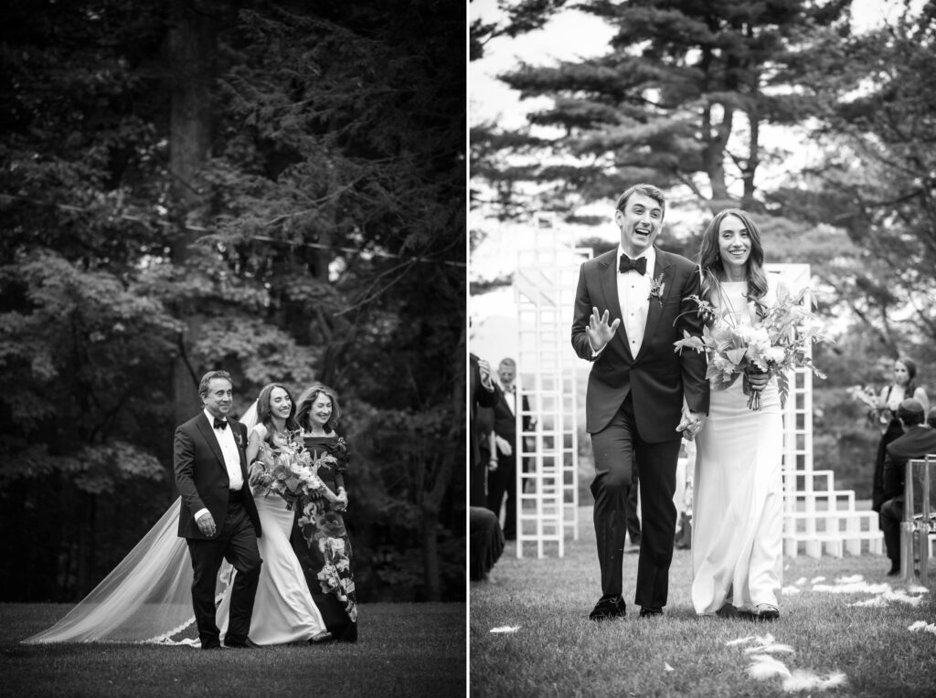 A black and white photo from Hudson Valley Weddings at The Hill depicts a joyful bridal party walking outdoors, with the bride and groom leading the way, smiling.