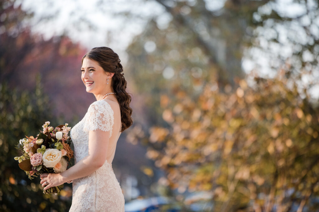 a bride holding flowers during her fall wedding at the rodin museum in philadelphia pa