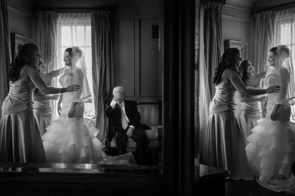 Black and white image of a bride and her bridesmaids laughing and getting ready in a Park Savoy wedding room, reflected in a mirror where an elderly man sits quietly observing.