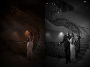 Elegant couple posing on a grand staircase under a crystal chandelier at The Mansion on Main Street wedding, in a monochrome setting.
