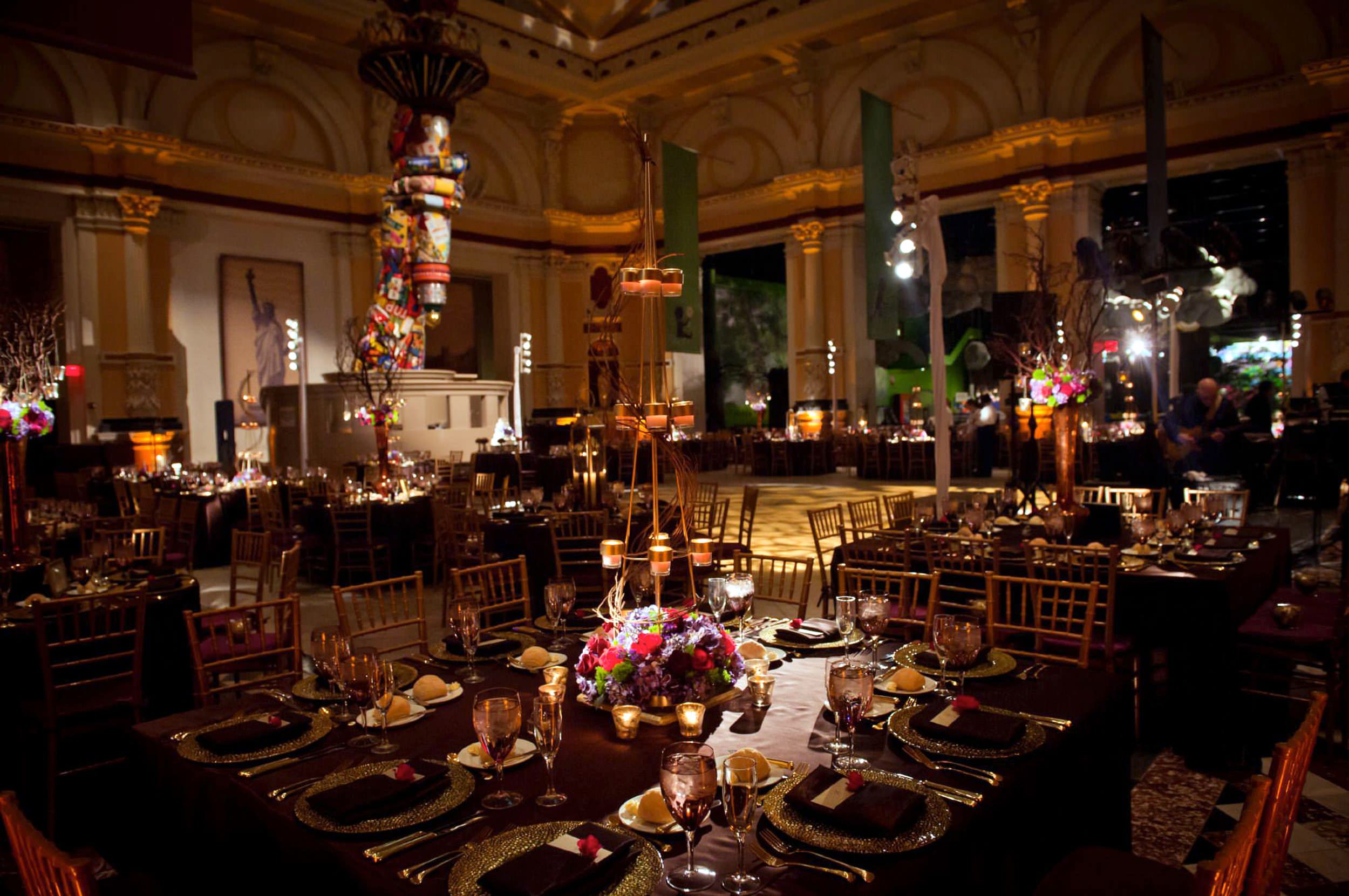 Elegant Please Touch Museum wedding setup with decorated tables, floral centerpieces, candles, and a dance floor, ready for the event.