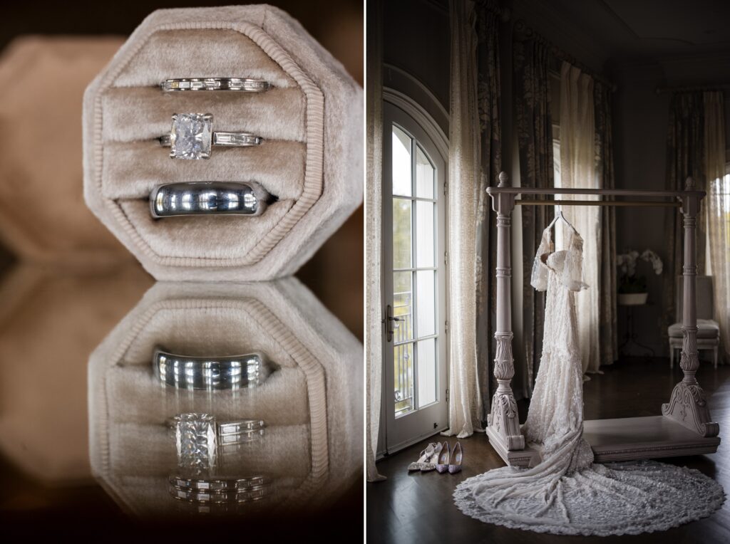 A pair of wedding rings and an engagement ring in a velvet box next to a white wedding dress hanging from a bed canopy in a room with large windows and curtains, capturing the elegance of a Park Chateau wedding.