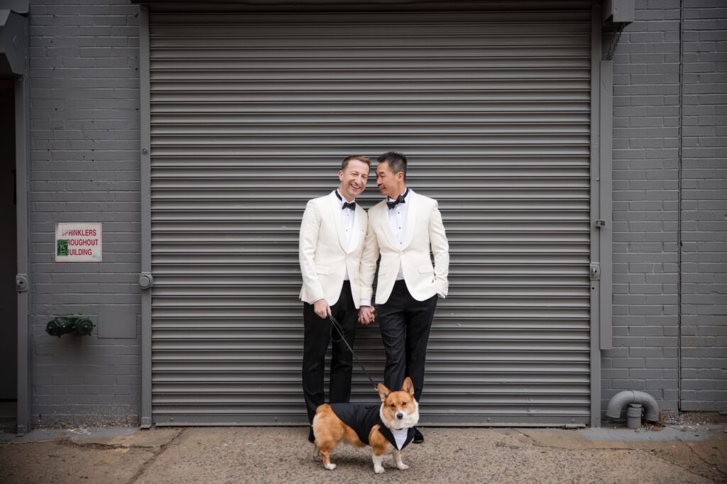 Two grooms cuddle in Williamsburg Brooklyn on their 74 Wythe rooftop wedding day