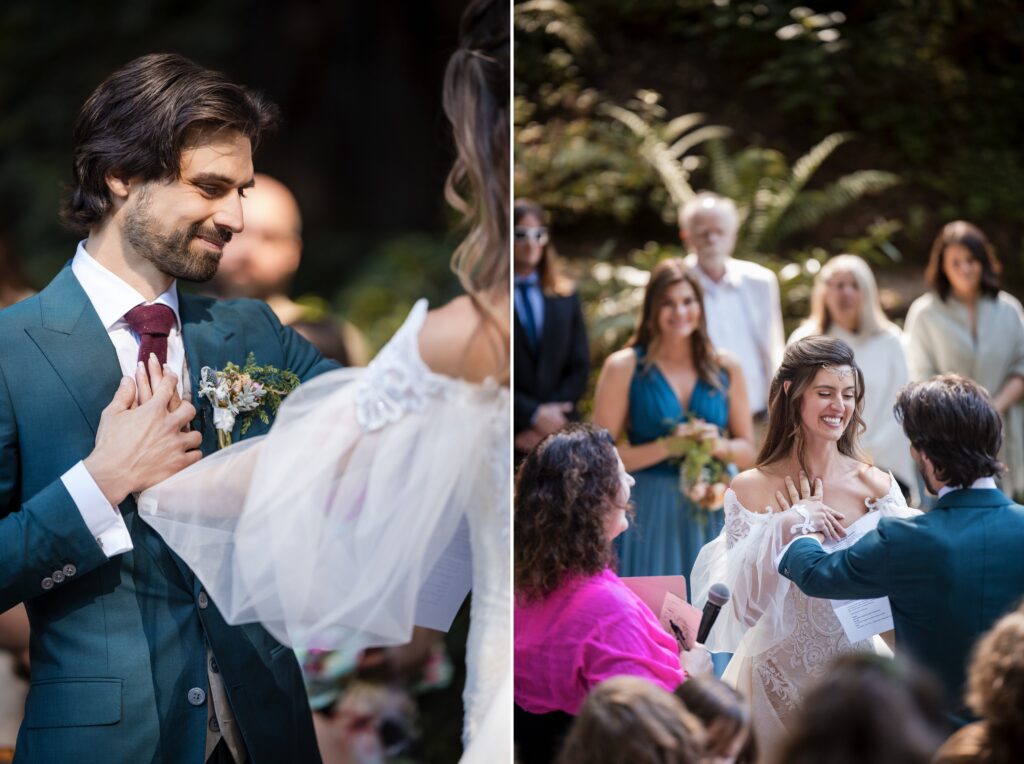 A couple exchanges vows in an outdoor Nestldown wedding ceremony. The groom, dressed in a teal suit, places a ring on the bride's finger, who is wearing an off-the-shoulder wedding dress as guests watch in the background.