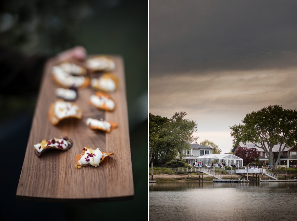 A wooden board holding various appetizers complements the picturesque waterfront scene, with charming houses and trees under a cloudy sky, reminiscent of a serene Westport Connecticut wedding setting.