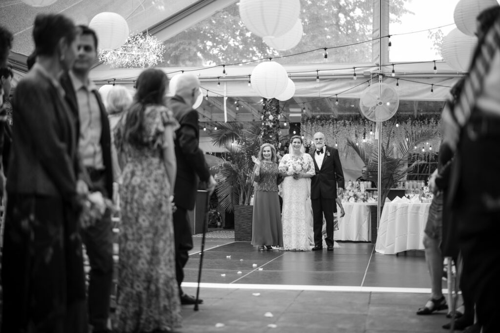 Bride and parents stand at ceremony