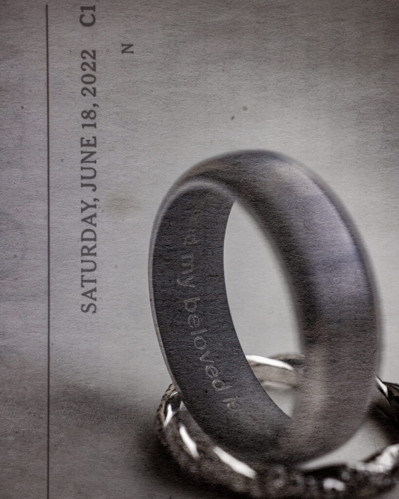 Close-up of a wedding ring engraved with 