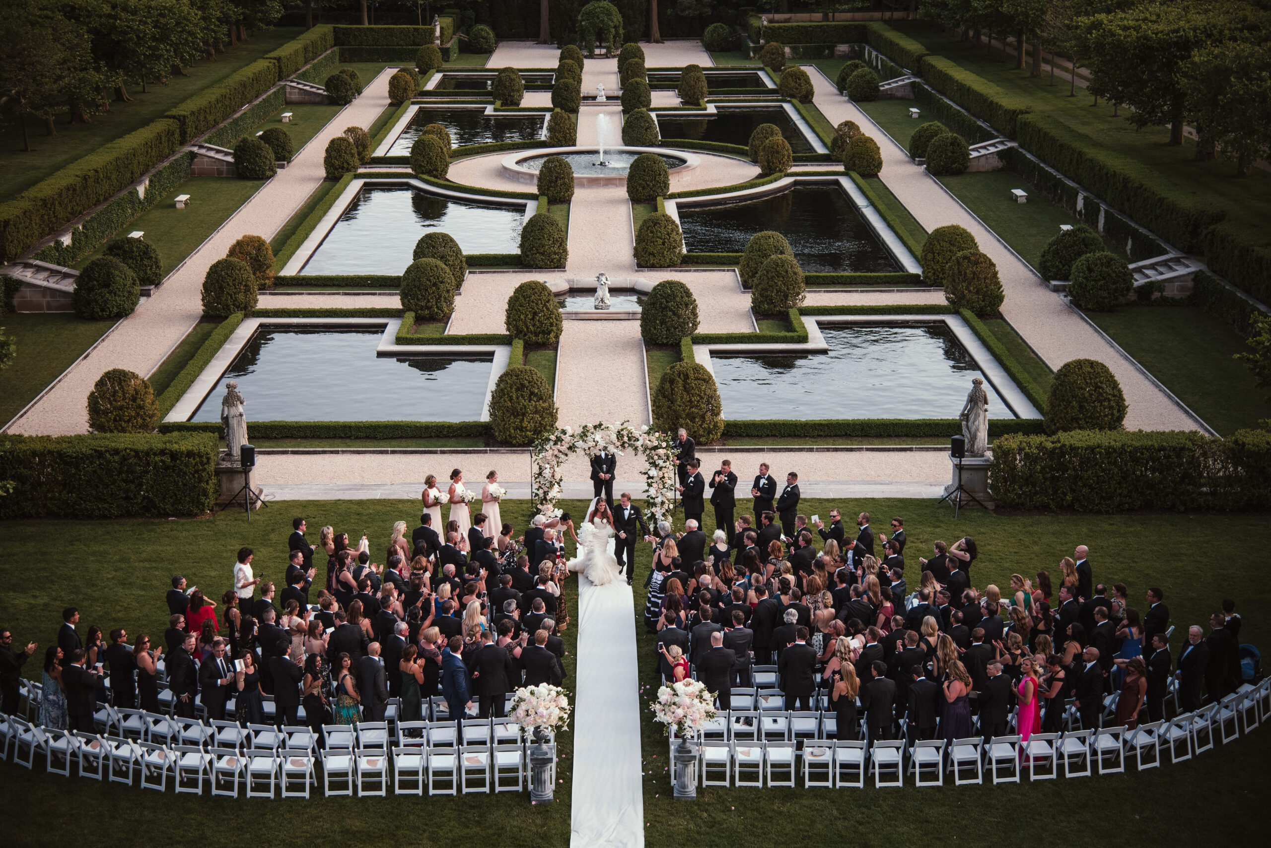 View from above of a wedding ceremony with beautiful gardens.