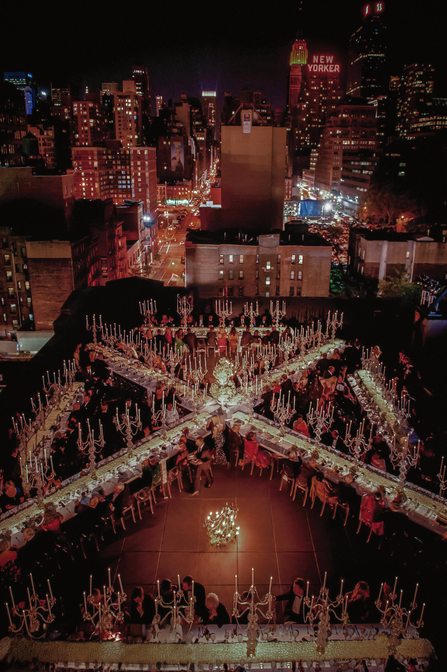 View from above of a wedding celebration in New York City, with the city lights surrounding them.