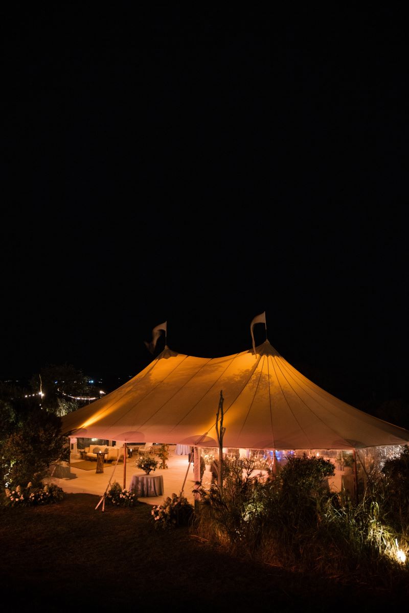 montauk wedding with a massive tent that is lit up with lights