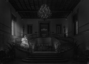 A bride walking on a spiral staircase in a castle